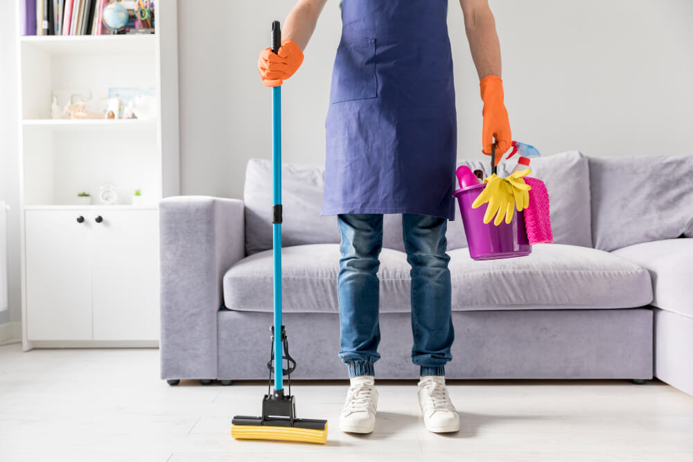 a man holding some cleaning materials